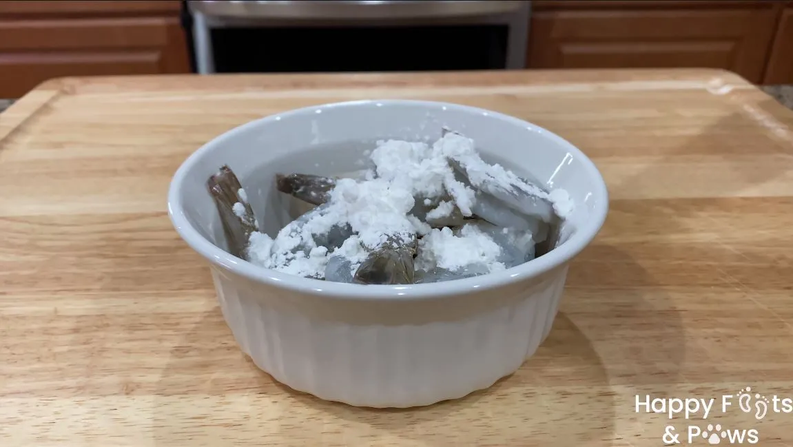 Raw tail on shrimp with corn flour in a bowl