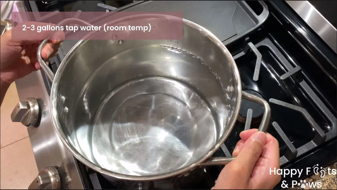 placing water in a pot to steam rice for puto maya recipe