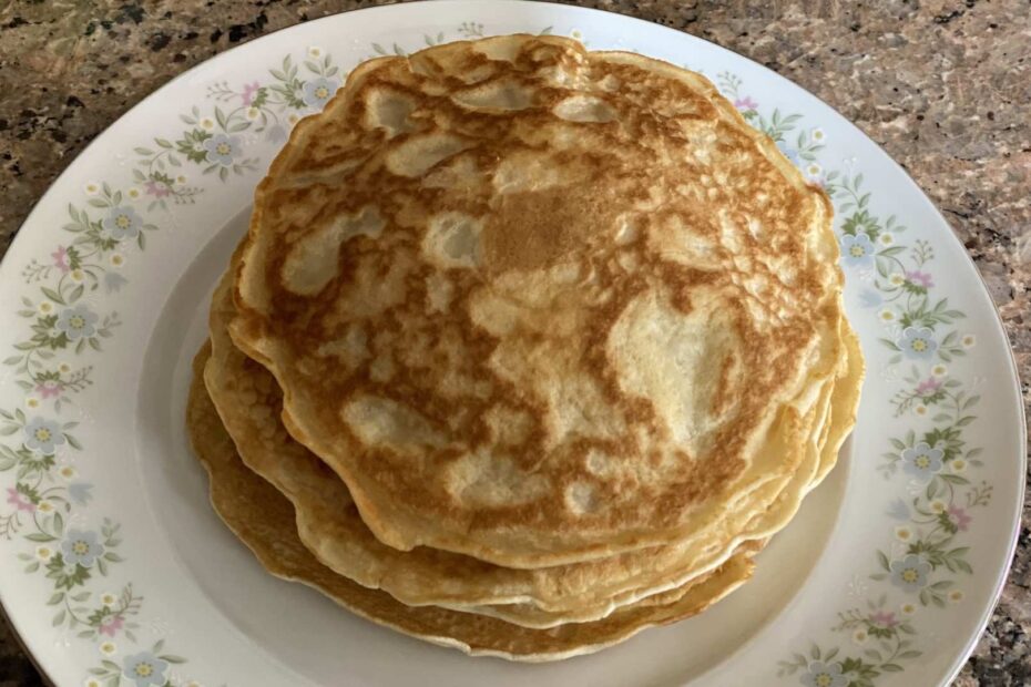 A stack of fresh homemade Filipino hotcakes on a dish with flowers