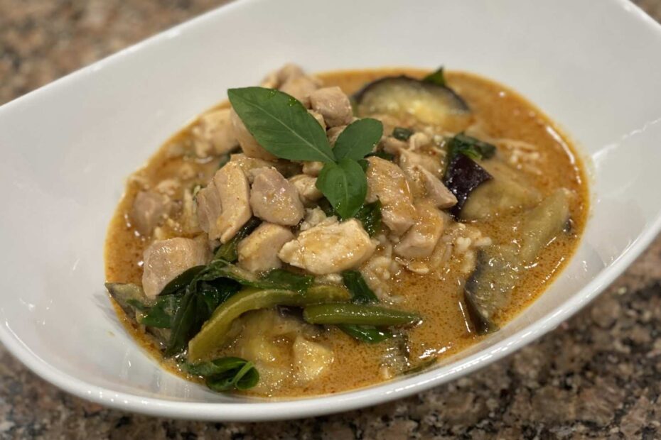 Bowl of panang thai curry with chicken. Includes Chicken, beans, eggplant, basil, and peanutbutter