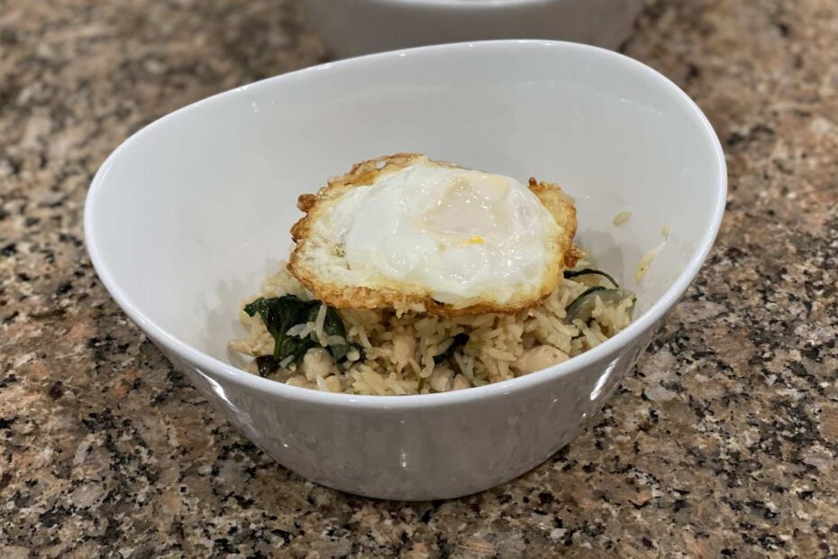 thai chicken fried rice with basil in a bowl. Fried egg on top