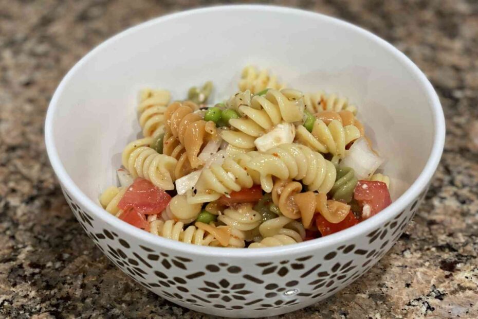 Pasta salad with onions, olives, tomato, feta cheese, and edamame.