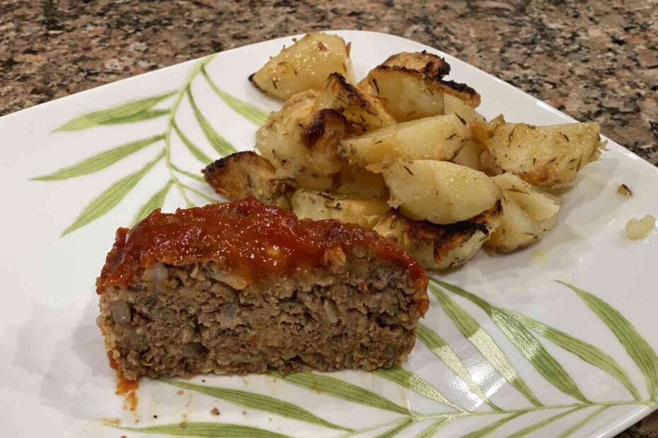 homemade meatloaf on plate with oven baked potatos