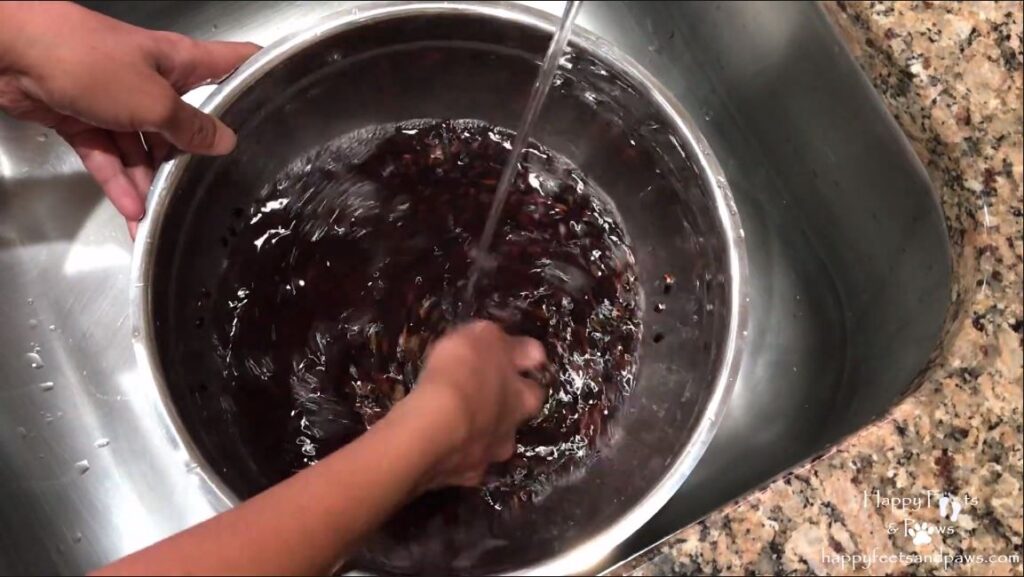 rinsing rice in a bowl for biko recipe