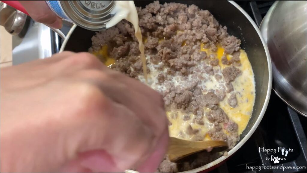 milk being added for sausage gravy in biscuits and gravy recipe