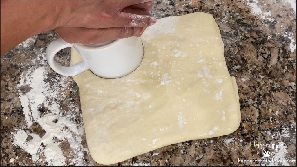 person cutting out biscuits for biscuits and gravy recipe
