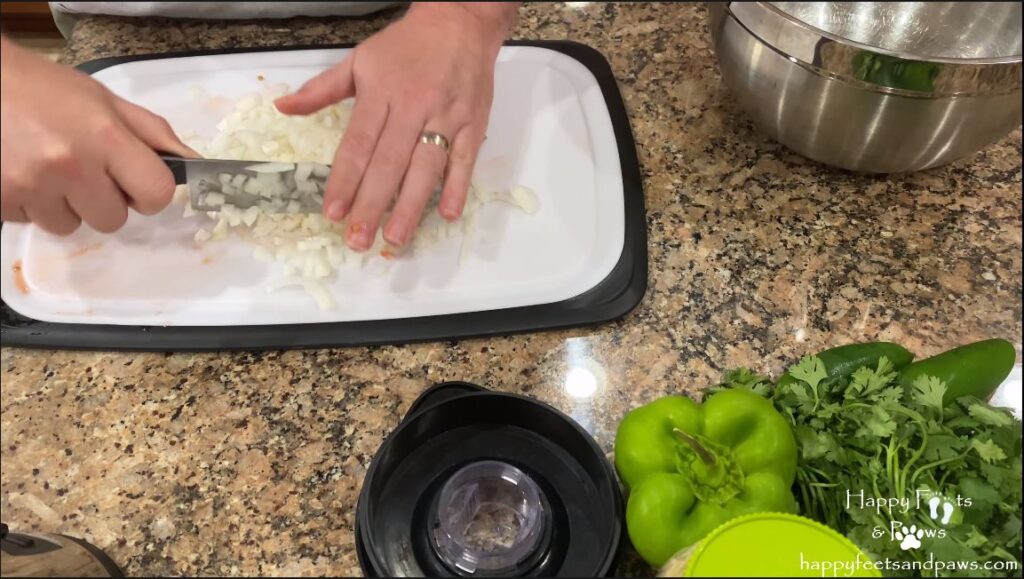 man chopping vegetables for black bean salsa recipe