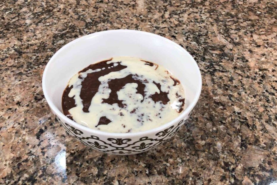 champorado in bowl with milk on top