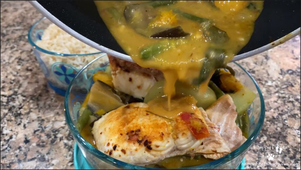 pouring sauce on fish in a bowl