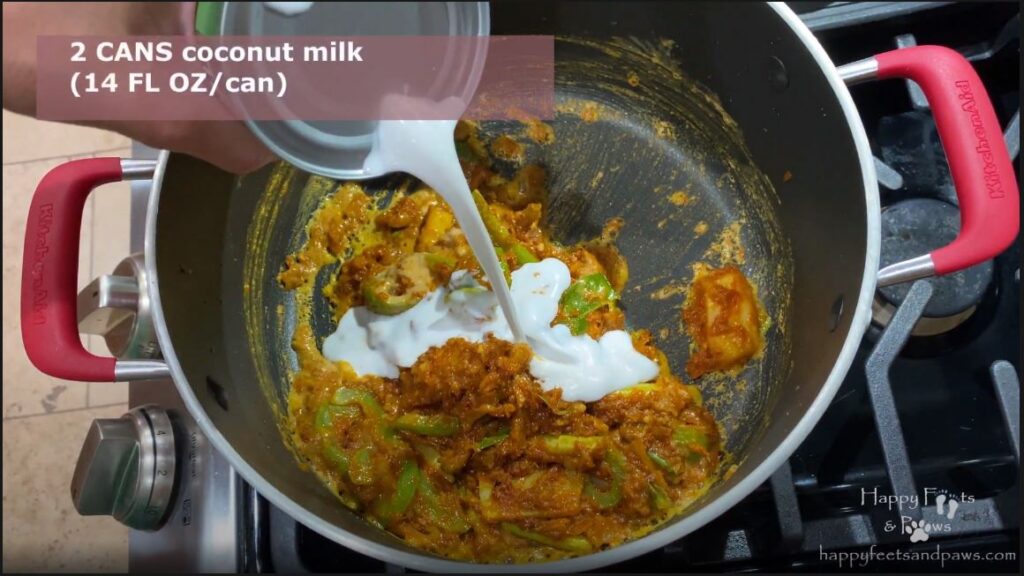 pouring coconut milk into pot for for panang curry recipe
