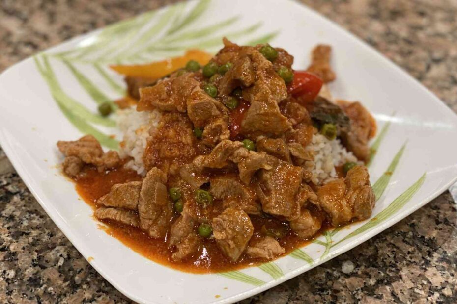 Pork Guisantes on a plate with white rice