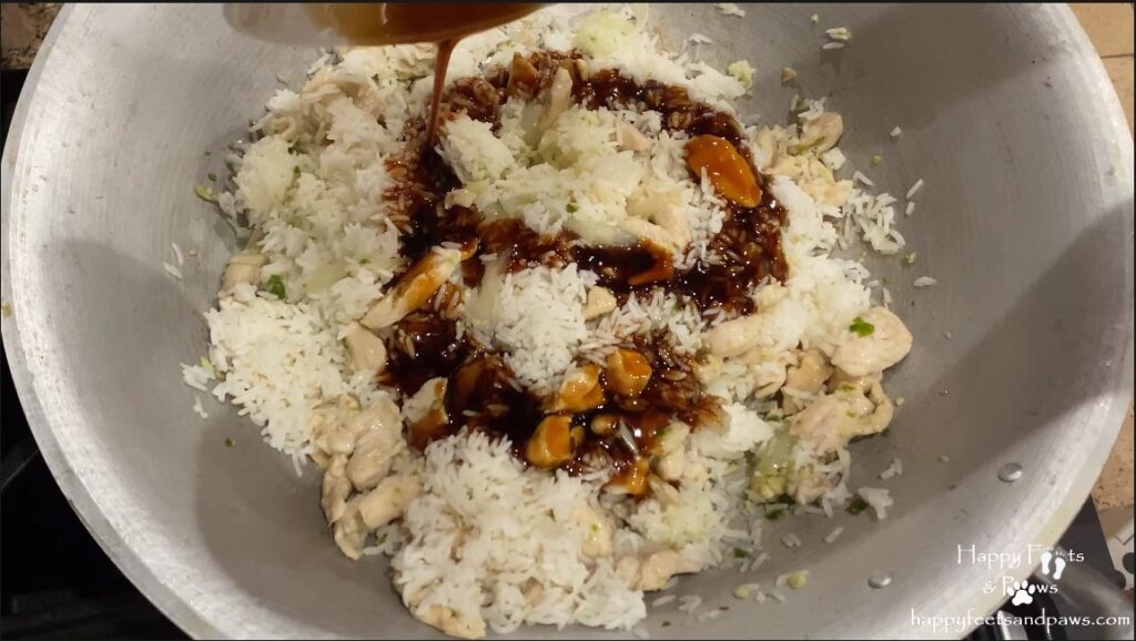 adding stir fry sauce to rice for thai chicken fried rice recipe