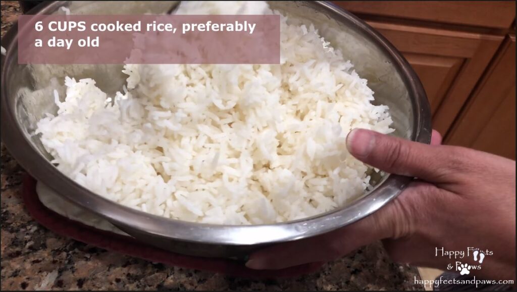 Seperating rice grain with a fork in prep for thai chicken fried rice recipe