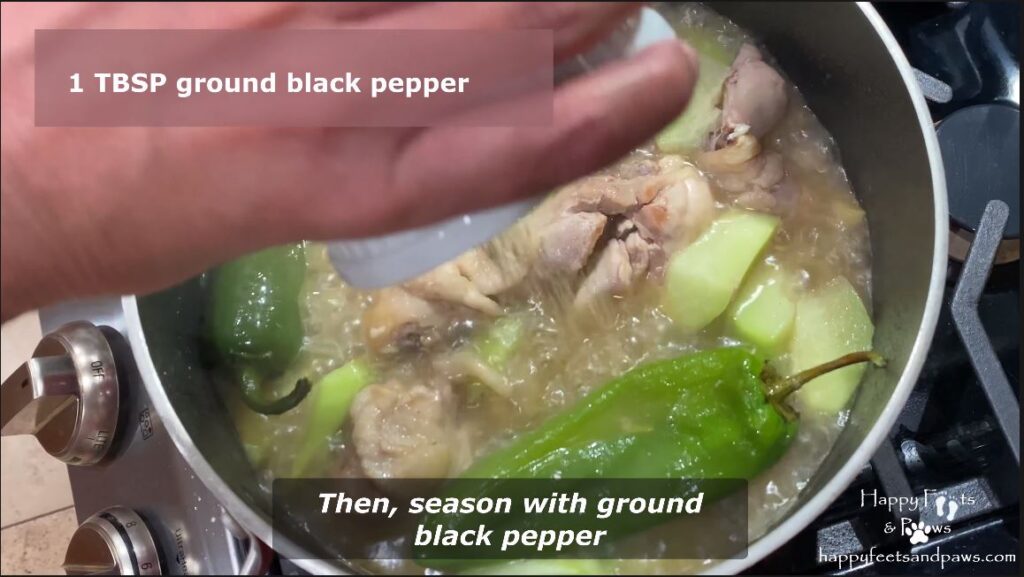 seasoning tinolang manok dish in a pot on the stove
