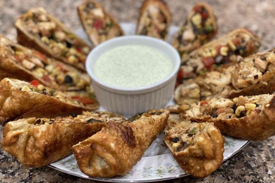 Southwest egg rolls on a plate with cucumber aioli sauce