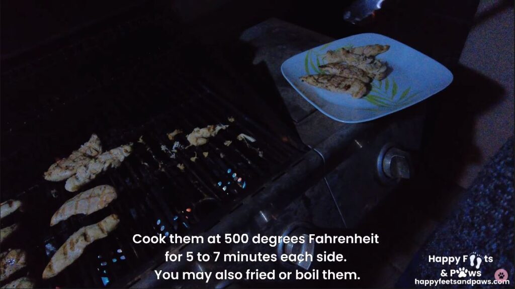 chicken being cooked on a grill