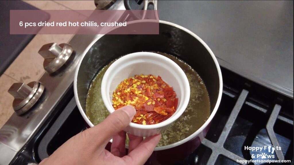 crush red peppers being placed in pot for sweet chili sauce