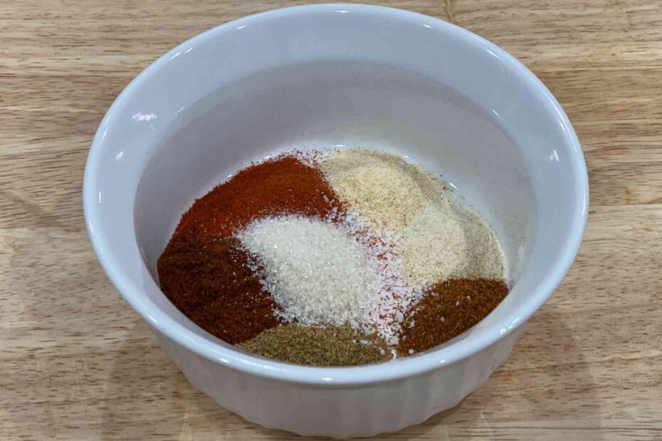 Fajita Seasoning in a bowl with cumin, chili powder, paprika, garlic powder, onion powder, cayenne pepper, kosher salt, and brown sugar