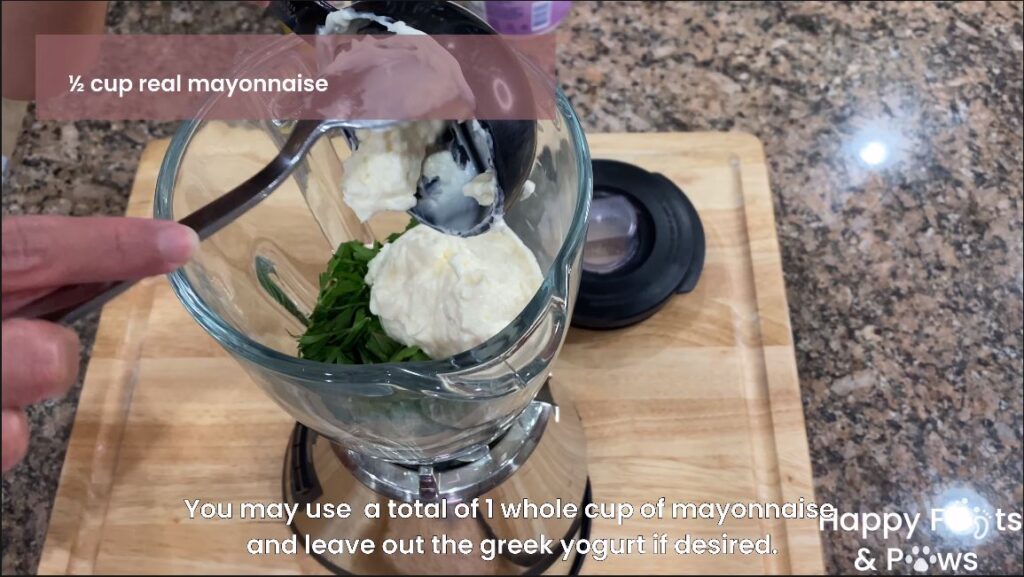 mayonnaise being added to a blender for creany garlic dressing