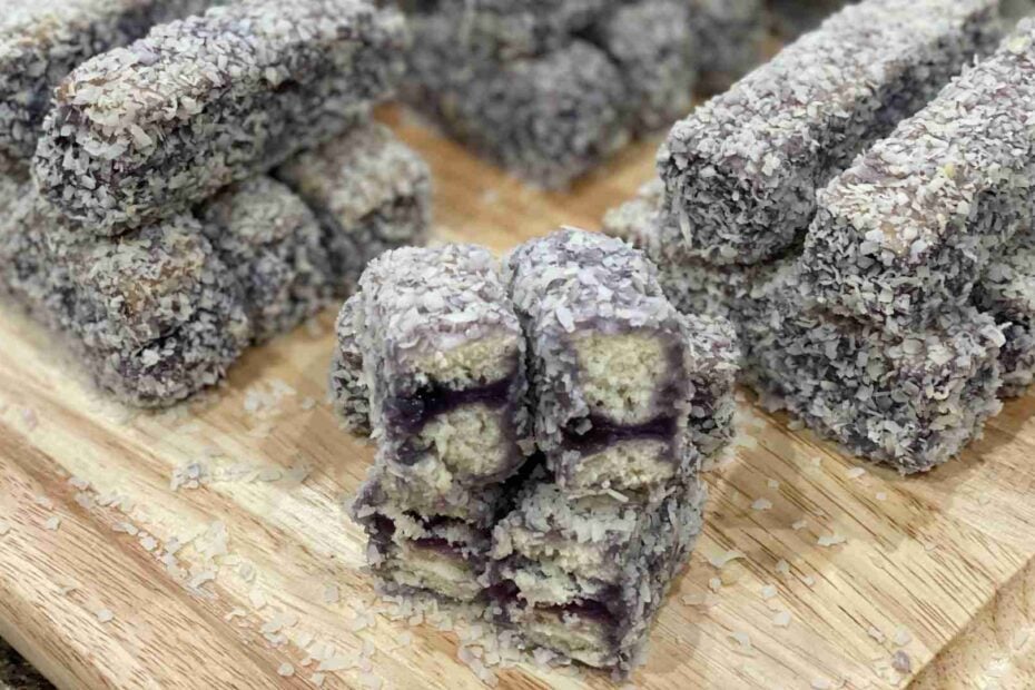 Filipino Ube Bars stacked on a wooden cutting board