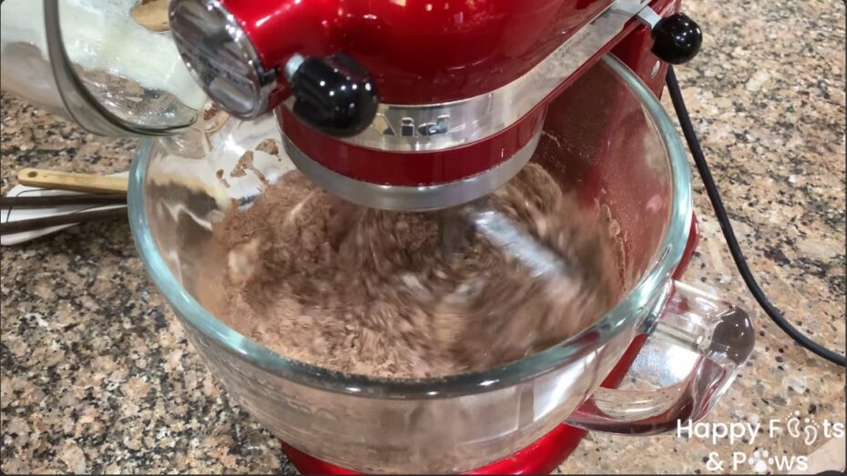 adding the wet ingredients to the dry ingredients in a stand mixer