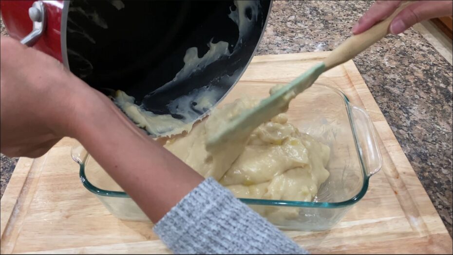 Moving the cooked maja blanca mix into a greased serving dish