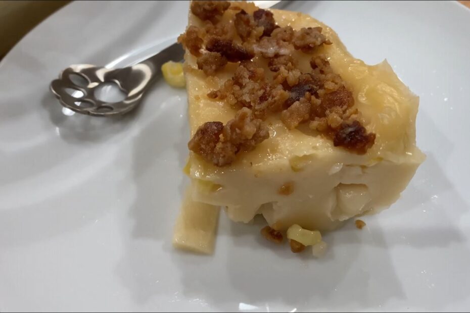 Maja Blanca slice on a plate with small spoon and latik on top