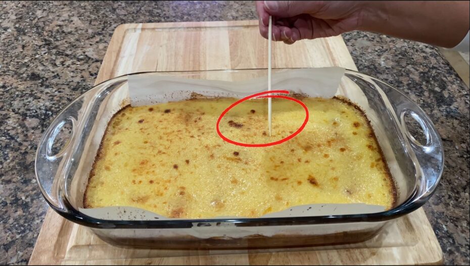 Checking to see if the Cassava cake is cooked using a small wooden stick