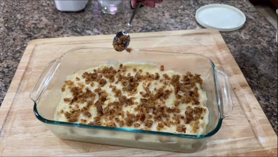 Adding latik to the top of maja blanca for additional flavor